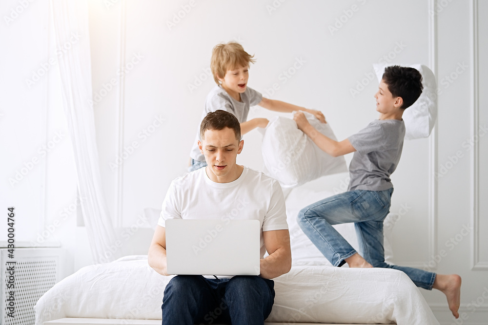 Work from home. Father working with children and laptop computer at home. Quarantine and closed school during coronavirus outbreak. Work from home. Father working with children and laptop computer at home. Quarantine and closed school during coronavirus outbreak.