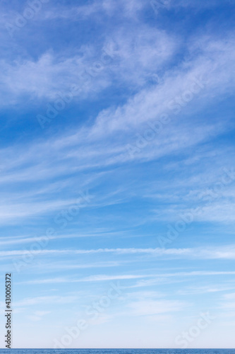Beautiful sky over the sea with cirrus clouds. Horizon line