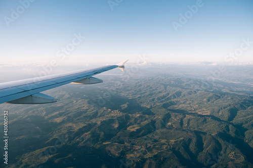 View from the plane window of the green mountain ranges of Tuscany