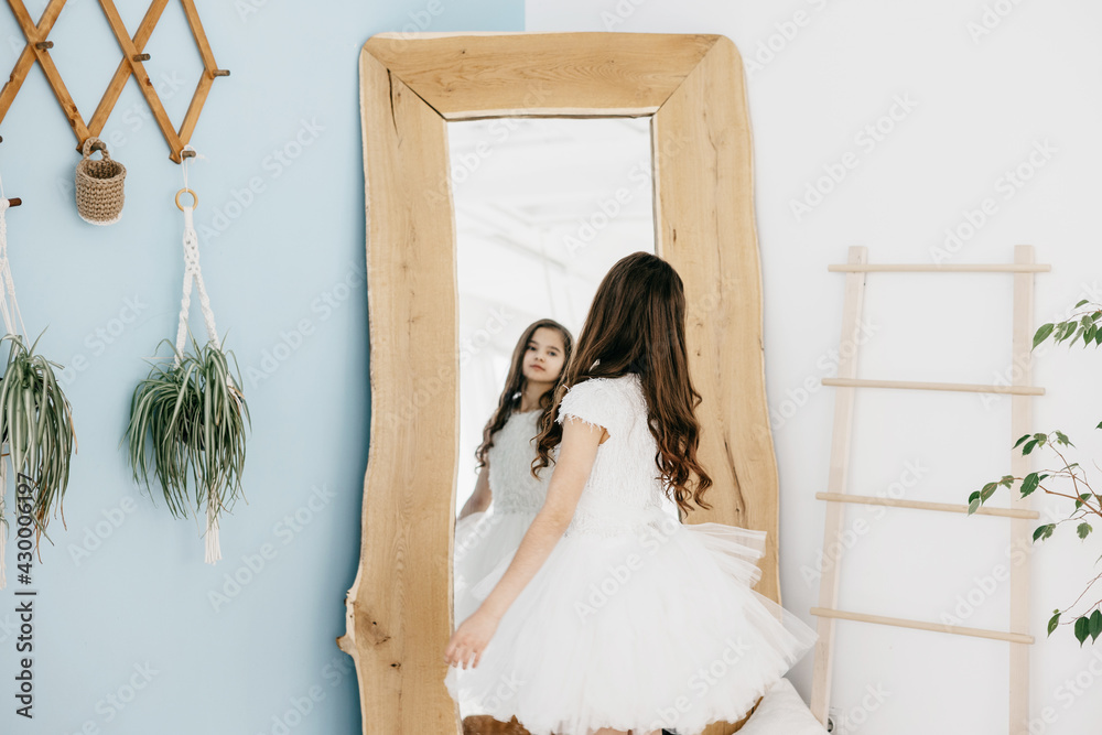 preteen flower girl in white dress with a bouquet of white gypsophila ...