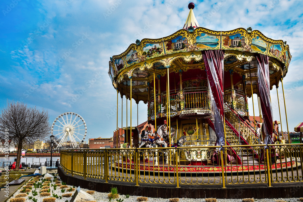 colorful carousel and ferris wheel in Gdansk, Poland colorful carousel and ferris wheel in Gdansk, Poland