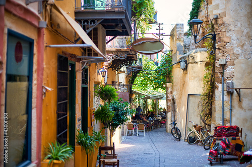 A cozy little street of a tourist town with cafes and restaurants. © Dmitry