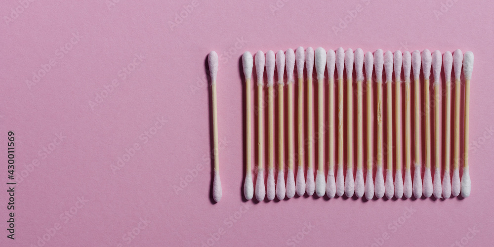 Pink bamboo cotton swabs in row. Flat lay pattern. Eco-friendly buds. Pink bamboo cotton swabs in row. Flat lay pattern. Eco-friendly buds.