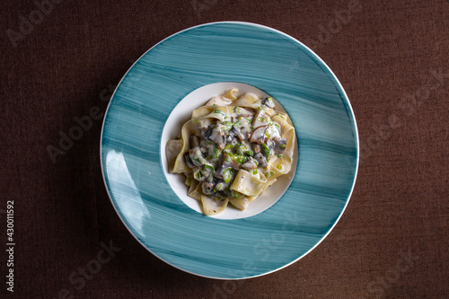 pasta with mushroom sauce on a blue plate view from top