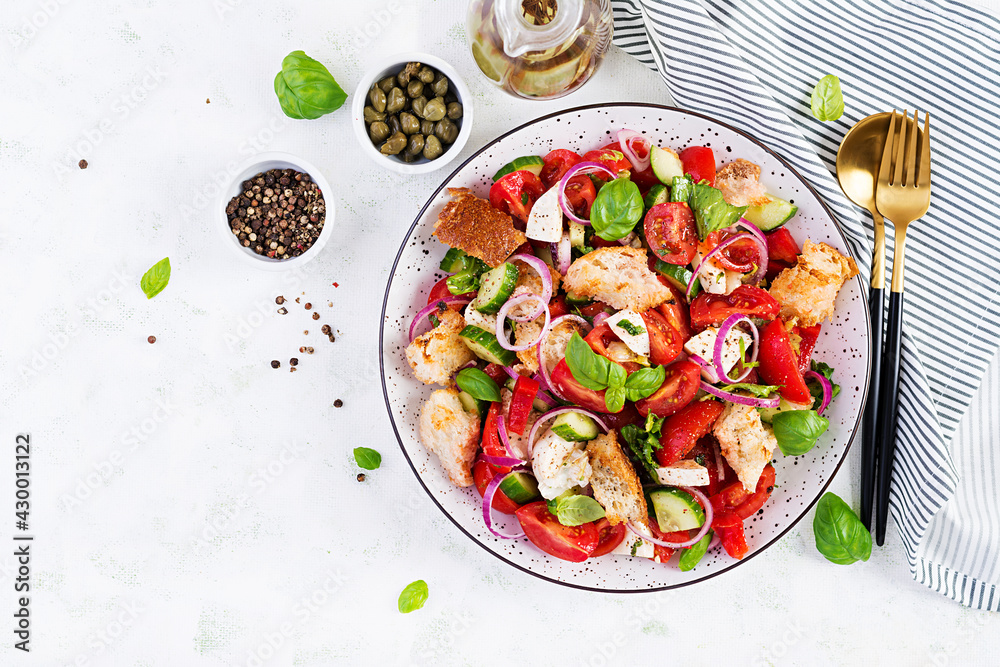 Traditional italian tomato salad panzanella with mozzarella, capers, red onion and croutons. Summer salad. Top view, flat lay Traditional italian tomato salad panzanella with mozzarella, capers, red onion and croutons. Summer salad. Top view, flat lay