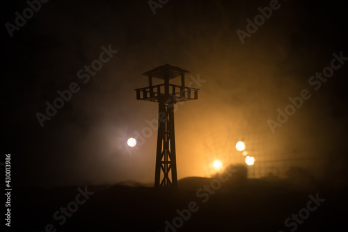 Creative artwork decoration. Silhouette of army watchtower at night. Selective focus