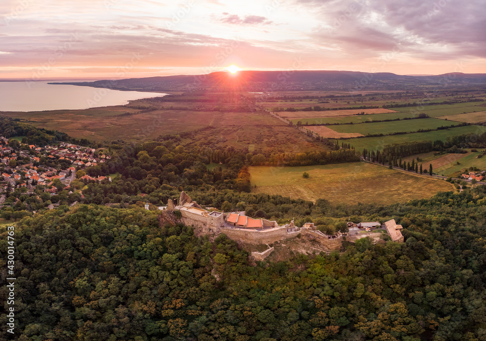 Aerial 4k drone view of the castle of Szigliget at sunset, a medieval fortress on a hill in Balaton Uplands, Hungary