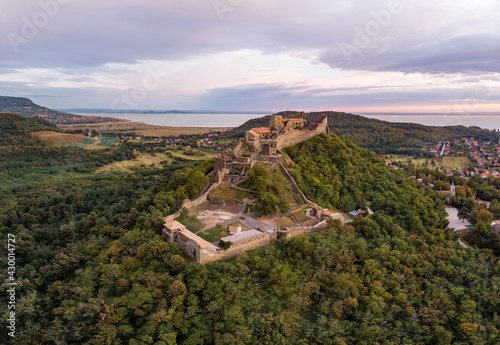 Aerial 4k drone view of the castle of Szigliget at sunset, a medieval fortress on a hill in Balaton Uplands, Hungary