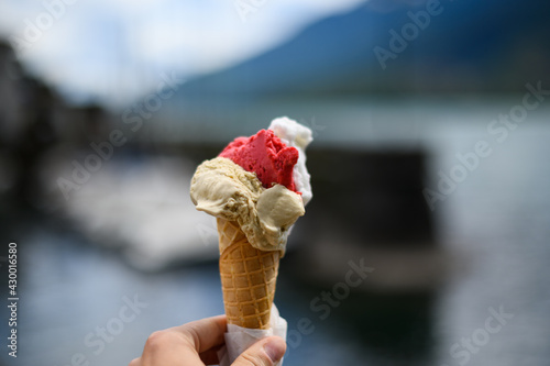 Italian ice cream cone in hand with blury background