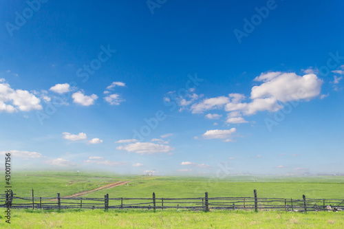 clouds on blue sky above green meadow