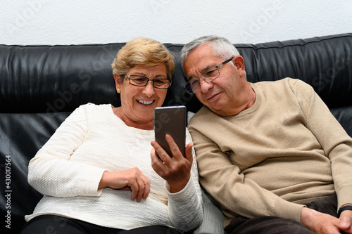Elderly couple looking at the mobile phone