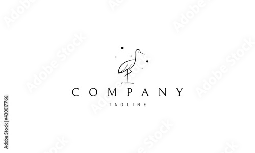 Vector logo nak which is an abstract image of a heron standing in the water against a background of stars.
