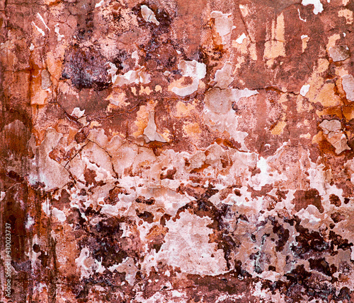 Aged brown cracked texture on the wall of the house.Colorful painted wall texture. Decorative wall luxury paint. Abstract grunge stucco art surface