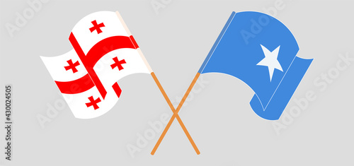 Crossed and waving flags of Georgia and Somalia