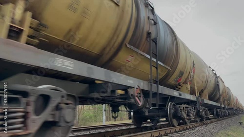 Long freight train rolling by a rural area on its way . High quality 4k footage