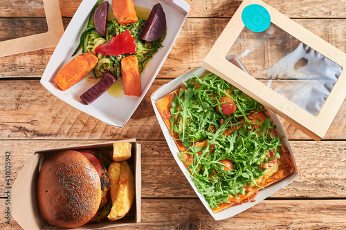 Canvas-taulu from above view of hamburger, pizza and salad packed for take-out or delivery