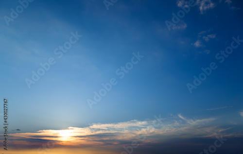 beautiful sunset sky, bright sunlight and silhouette of clouds as a background