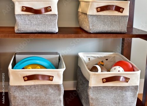 Easy simple child's toy storage in living room or bedroom for modern look and and quick clean up. Photo background, lifestyle, house and home photo