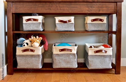 Easy simple child's toy storage in living room or bedroom for modern look and and quick clean up. Photo background, lifestyle, house and home
