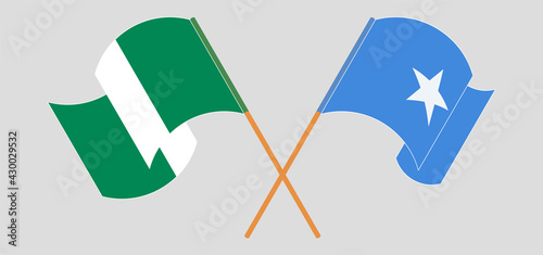 Crossed and waving flags of Nigeria and Somalia