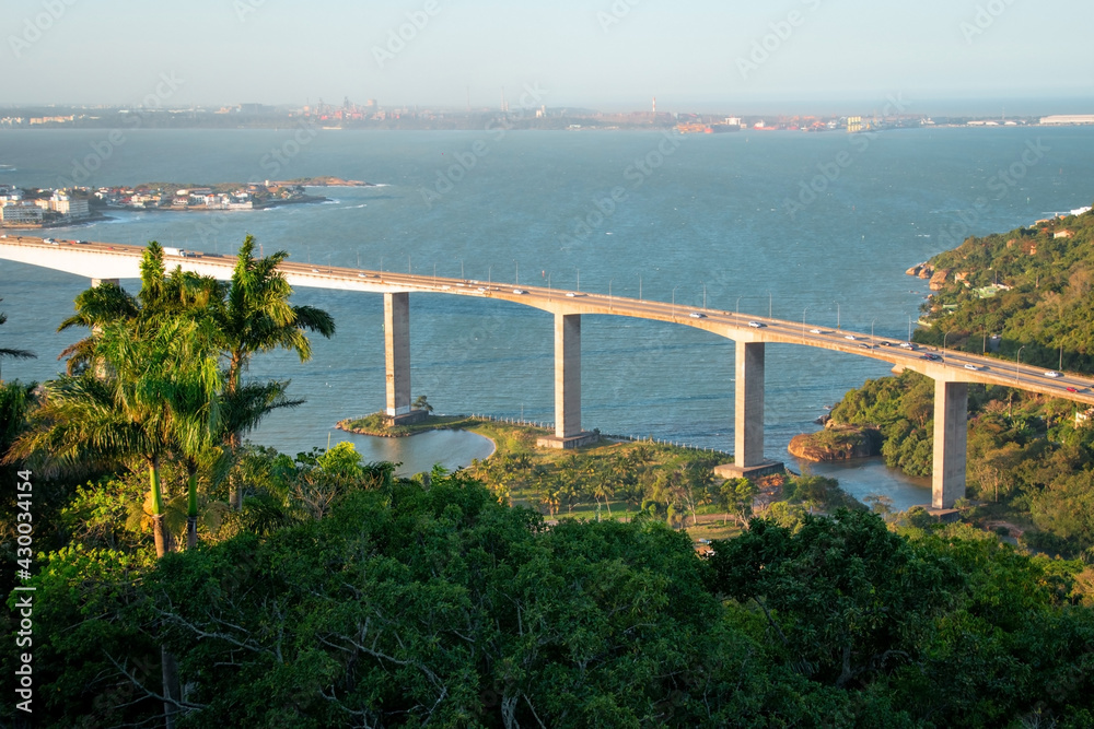 Naklejka premium aerial view of the bridge over the sea and tropical trees