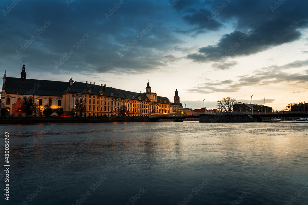 sunset over the oder river and view of the old town of wroclaw in poland