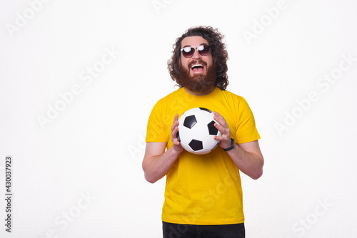 It&#039;s soccer time. Bearded man is holding a football ball.