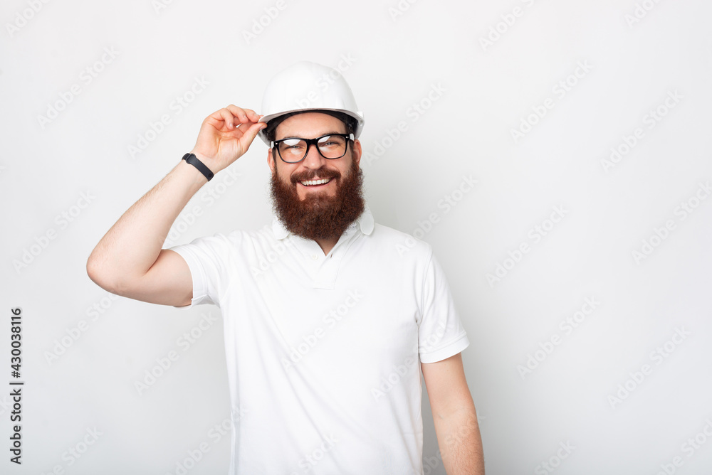 Handsome bearded engineer is smiling at the camera over white background. Handsome bearded engineer is smiling at the camera over white background.