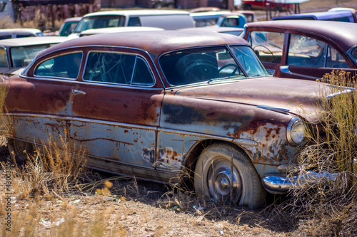 Exterior of a junked vintage retro vehicle in a junkyard.