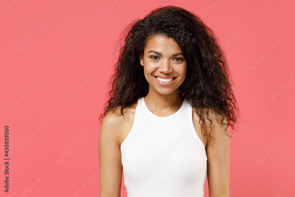 Young fun smiling happy cheerful friendly satisfied positive cute african american woman 20s wearing casual white tank shirt looking camera isolated on pink color background. People lifestyle concept Young fun smiling happy cheerful friendly satisfied positive cute african american woman 20s wearing casual white tank shirt looking camera isolated on pink color background. People lifestyle concept