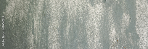 Vintage wall texture. Weathered rough surface of a painted wall. Pattern with faded paint. Wide panoramic texture for background and design.