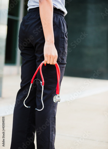 healthcare professional with stethoscope in hand