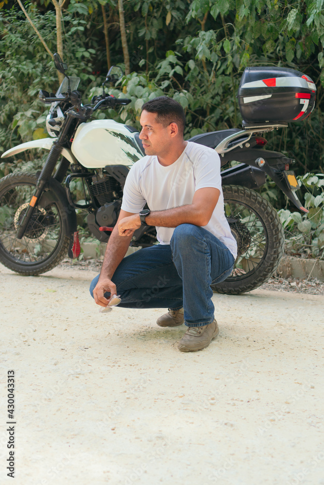 Serious young ethnic biker in casual clothes near motorcycle Stock-Foto |  Adobe Stock