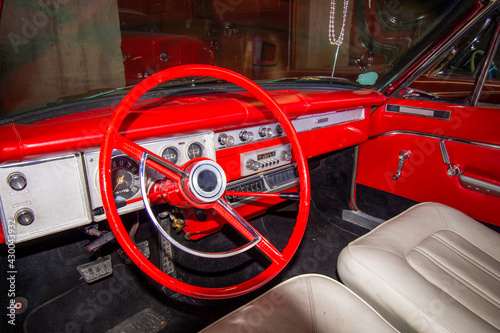 Interior of a junked retro vehicle with a dirty dash board in a junk yard. © Get Lost Mike