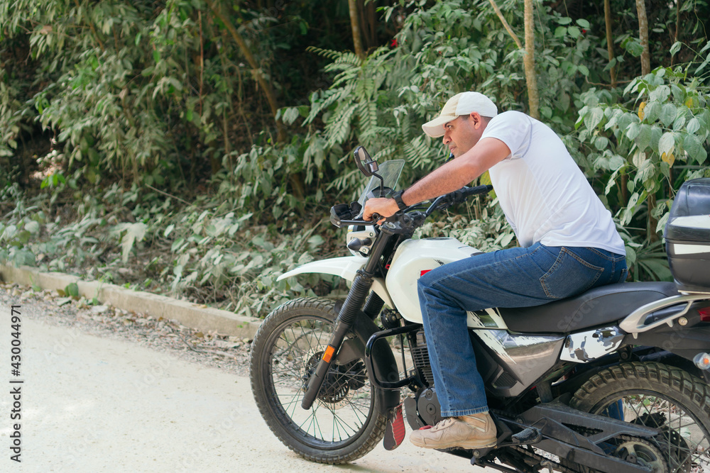 Fototapeta premium Motorcyclist starting his journey after resting
