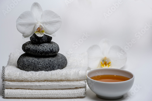 spa style  white towels  honey cup  Zen stones  orchid  everything for a relaxing massage