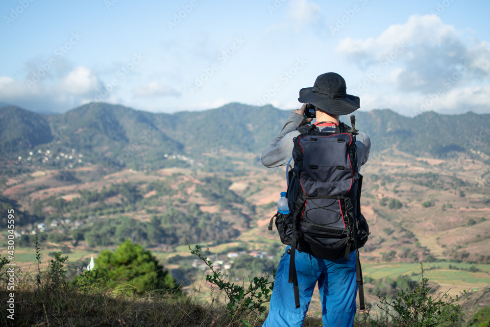 A tourist backapacker taking a photo in Shan state, Myanmar A tourist backapacker taking a photo in Shan state, Myanmar