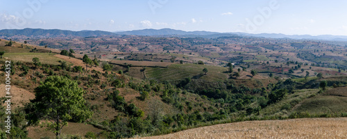 Panorama of rolling hills and farm lands with rice fields in Shan state  Myanmar