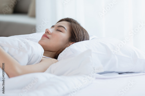 Asian women sleeping and sweet dream on white bed in bedroom