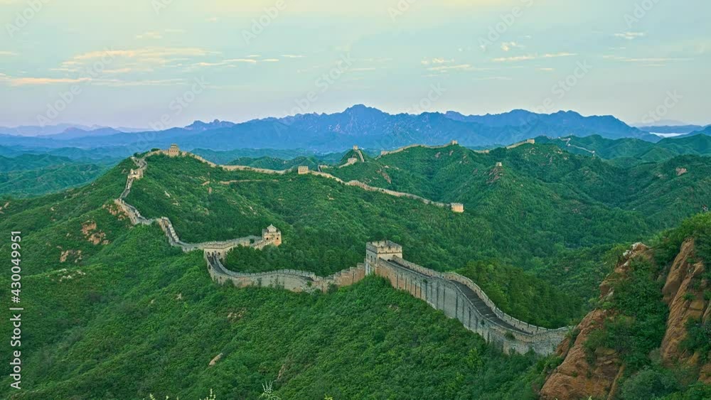 Clouds flowing over green Great Wall of China, time-lapse of light and shadow 