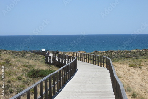 walkway to the beach in the sands in Algarve Southern Portugal. © everton