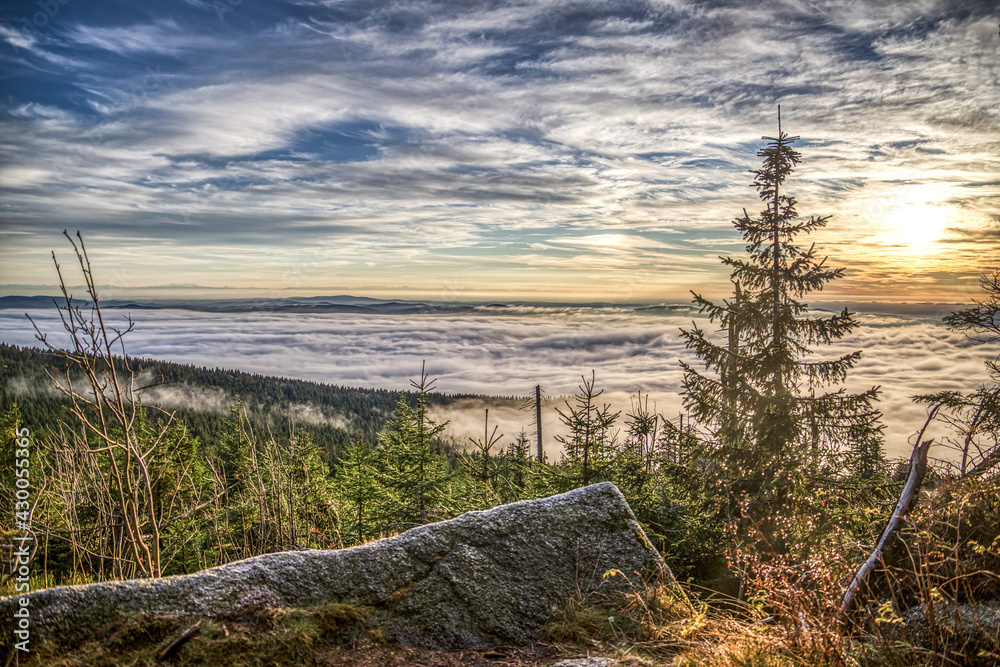 foggy view at sundown on mount Dreisessel, a mountain in the bavarian forest