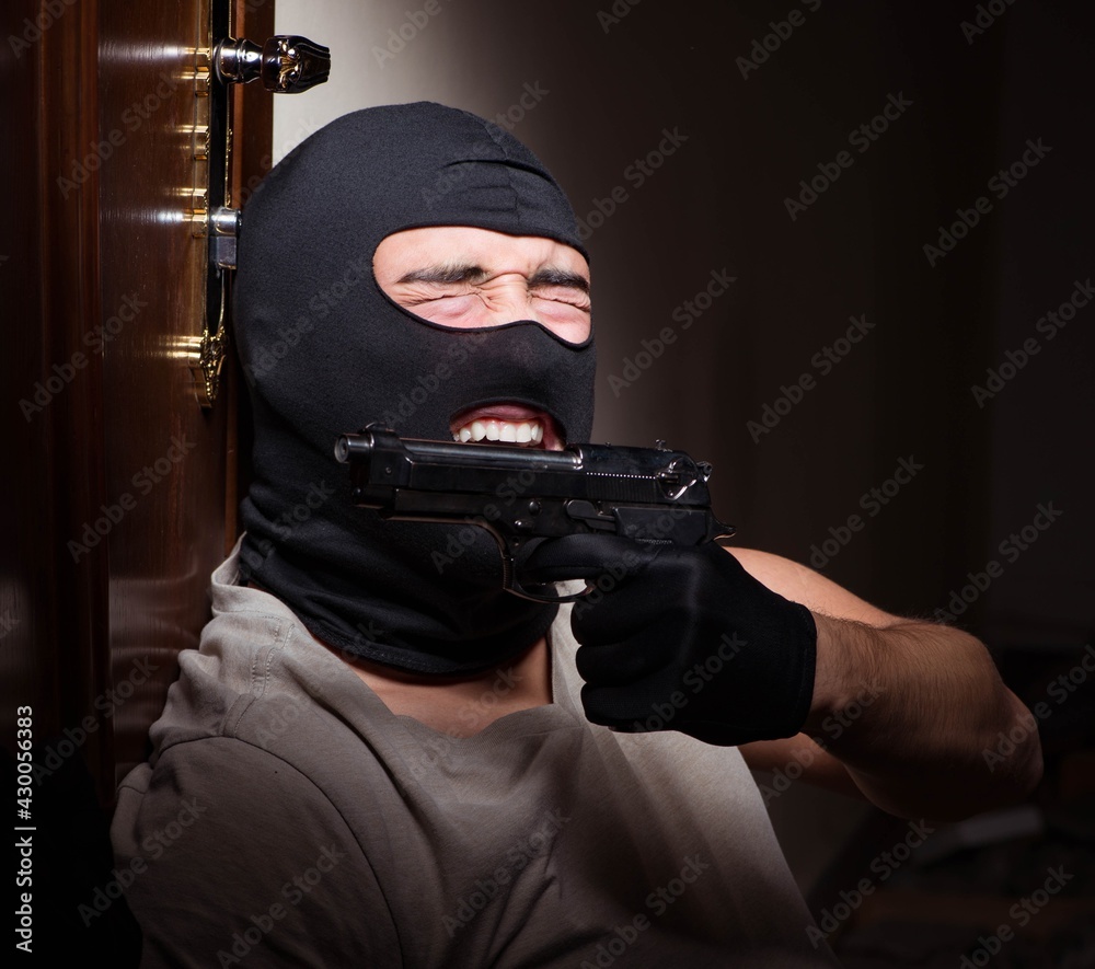 Burglar wearing balaclava mask at crime scene Burglar wearing balaclava mask at crime scene