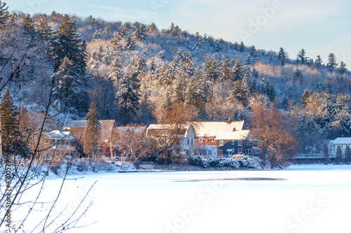 Red Barn amidst snow covered trees on a hillside in winter, December 2019