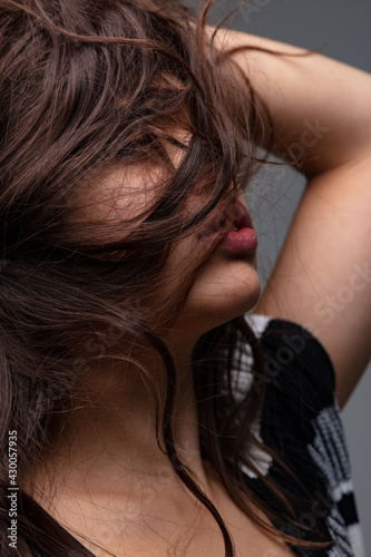 Sensual young woman with her long hair covering her face