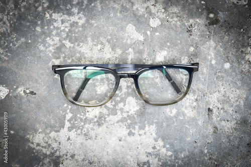 Clear eyeglasses, Glasses transparent dark blue frame Vintage style on grungy concrete cement floor background