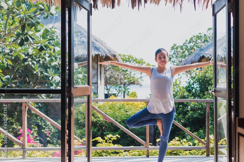 Asian beautiful woman exercise and play yoga at home.Concept of Exercise during the quarantine at home for preventing coronavirus and covid-19 infection. Asian beautiful woman exercise and play yoga at home.Concept of Exercise during the quarantine at home for preventing coronavirus and covid-19 infection.
