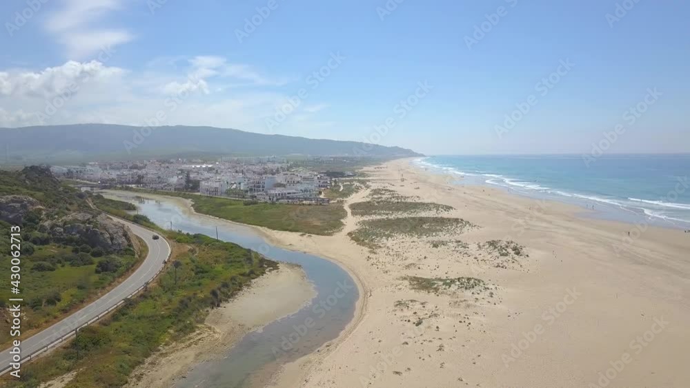 Aerial panoramic view of Zahara de Los Atunes and its sandy beaches on a sunny day. Aerial panoramic view of Zahara de Los Atunes and its sandy beaches on a sunny day.