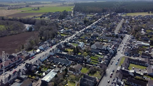 Aerial view of the Scottish town of Edzell on a sunny spring day, Angus, Scotland. Right to left rotating pan over the north end of the town. photo