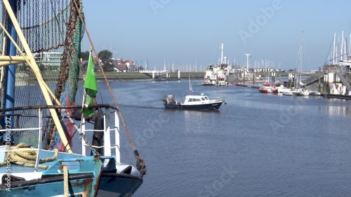 Fishing boat turning on the river at the harbor of Nieuwpoort, Belgium - static shot photo